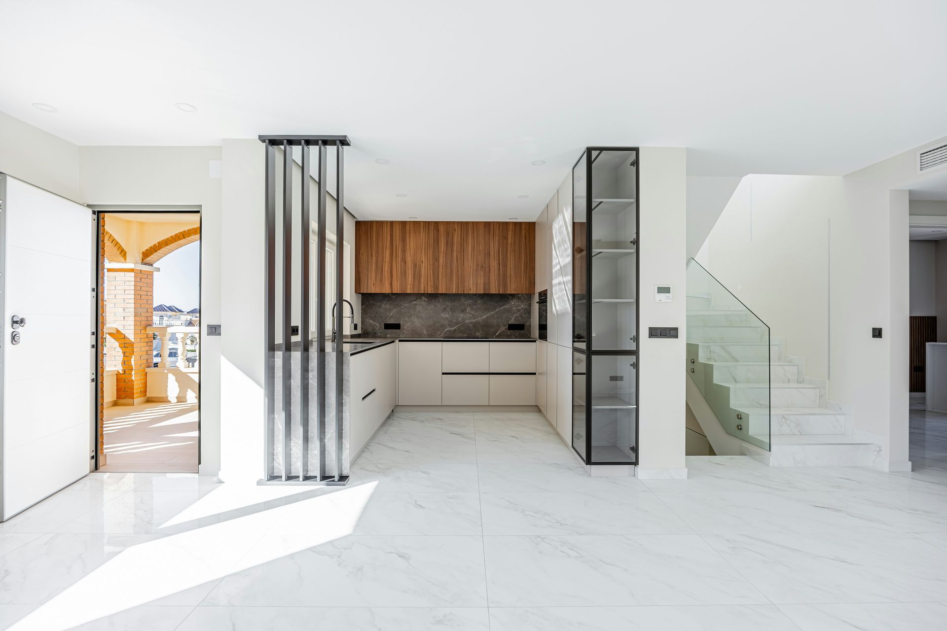 Modern kitchen with wooden cabinets and marble floors